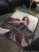Full view of the Taylor Swift Speak Now woven blanket measuring about 60x48 inches laid out.