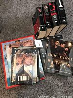 Collection of 6 Twilight books and movie companion books along with several Titanic collectible items including VHS tape, CD, books and magazine.