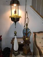 Hanging oil lamp with chain, mesh cage, statue center and faux greenery at base