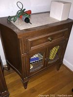 Two matching vintage wooden nightstands with light marble tops, showing front and side views, condition and design details.