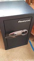 Front view of Sentry Safe showing the full safe and the handle with combination dial.
