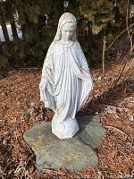 Full view of the Blessed Virgin Mary garden statue showing overall shape and weathered surface