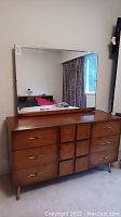 Full dresser with attached rectangular mirror, showing overall condition and size relative to surroundings