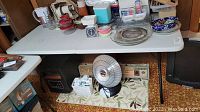 Full table covered with various items excluding the lot contents to clarify included item is only the table.