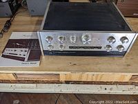 Accuphase C-200 unit and original owner's manual on wooden table