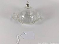 Clear glass butter dish with a dome lid showing pear motif