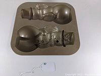 Top and rear view of Nordic Ware snowman cake pan showing two snowman molds, one front-facing and one side profile.