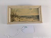 Full view of the framed coastal seascape oil painting on board with signature Hedwig.