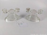 Pair of clear double candle holders, showing overall design and ribbed base