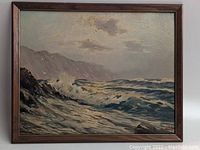 Full view of framed oil painting showing seascape with waves crashing on rocky shore and cloudy sky