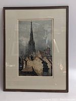 Full view of framed and matted etching showing cathedral spire and rooftops