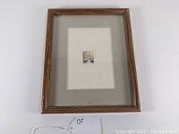 Framed watercolor painting with a cream mat and wooden frame, overall view.
