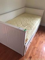 Overall view of assembled daybed with yellow mattress