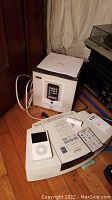 Overview showing Bose Wave Radio/CD unit, remote control atop unit, Apple iPod Classic and iPort 1W-21 box