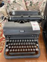 Front view of the vintage Royal typewriter showing the keyboard, Royal brand nameplate, and paper roller.
