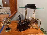 World time zones clock, Panasonic cordless phone on base, brass-tone clock