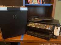 Epson printer and NoviTech paper shredder side by side on table.