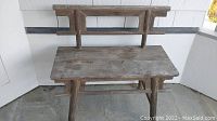 Front view of elm wood vintage ShanXi Chinese bench with visible weathered and cracked seat and geometric backrest structure.