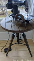 Side table round wood slatted top with sewing machine and iron items shown for scale (not included)