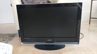Front view of the Vizio 26-inch flat screen television on stand.