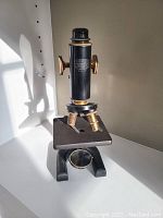 Front view of the vintage Spencer Buffalo microscope showing overall structure and magnification tube.