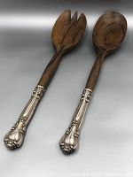 Front side view showing wooden salad fork and spoon with silver Birks handles