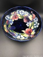 Top-down view of the interior of the blue ceramic bowl showing the floral design.