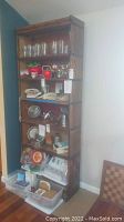 Front view of oak barrister bookcase with items on shelves