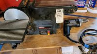 Craftsman belt/disc sander next to a Craftsman corded drill on a wooden surface.