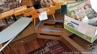 Wood sewing organizer partially open with Black & Decker iron and other items on table