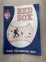 Front cover of 1963 Boston Red Sox Yearbook showing baseball action scene and Johnny Pesky portrait.