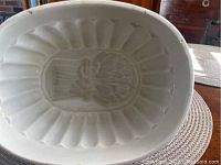 Top view showing internal grape or floral design of the antique white ironstone jelly mold with fluted walls.