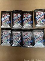 Front view of 8 factory sealed foil packs of 1990-91 Upper Deck NHL Hockey Premiere Edition collector cards arranged in two rows of four.