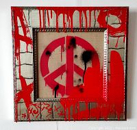 Front view of painting showing red peace symbol and silver frame against white wall