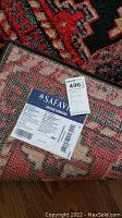Photo of the backside label of the rug showing Safavieh branding and Vintage Hamadan collection details along with size 6'7" x 9'