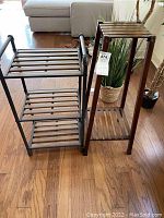 Photo showing the three-tier slate wooden shelf with black metal faux pipe-style frame next to the wooden slatted plant stand shelf.