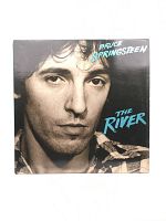 Front cover of Bruce Springsteen The River album showing black-and-white close-up photo of Bruce Springsteen with album title in blue text.