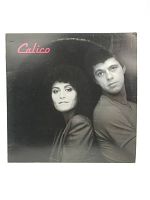 Front cover of the Calico vinyl LP showing a monochrome photo of a woman and man with the title in pink text.