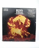 Front cover of the KISS The Originals limited edition 3-record set showing fiery explosion with band member faces.