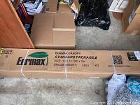 Long rectangular box labeled “Eurmax Canopy Standard Package Size: 10' x 10' / 3m x 3m” strapped and sealed