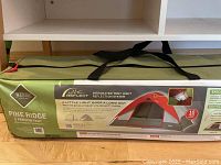 Photo of Pine Ridge 5 person tent carry bag showing product branding, Lite Reflect technology, 10-year warranty, and product features.