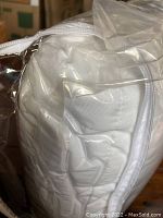 Full size white comforter quilted and packed in a clear zippered plastic bag.