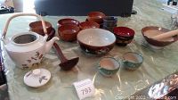 Full lot showing all assorted dishware including wooden bowls, tea kettle, ladle, mortar and pestle, and cups.