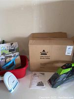 Overview of lot: Bissell Little Green Model 1400E in box, assembled unit, red brush & dustpan set, white & blue steamer