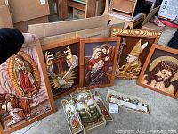Group shot of all six decor pieces arranged on floor showing multiple religious 3D wood panels and ceramic pieces.