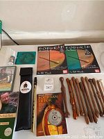 Photo of all instructional materials with books, CDs, videos, wooden beaters, and accessory pouch laid out on table