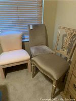 Three chairs shown together in corner; includes two fully upholstered chairs and one wood-backed carved chair needing repair