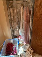 Several long silk drapes hanging, lined and clean, mostly floral and solid colors including pink and cream, visible length about 90 inches.
