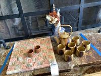 Image showing entire lot including the tea set, stone chess board, vase with dried flowers, and two stone cups on the chess board