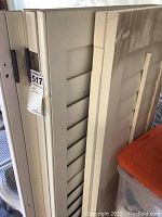 Two white wood shutter panels stacked, showing slatted design and overall height